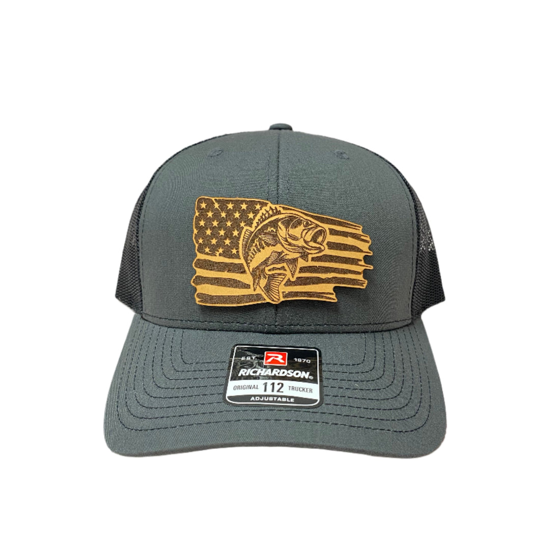 A gray 'Richardson 112' trucker hat with a leather patch featuring an American flag design on the front.