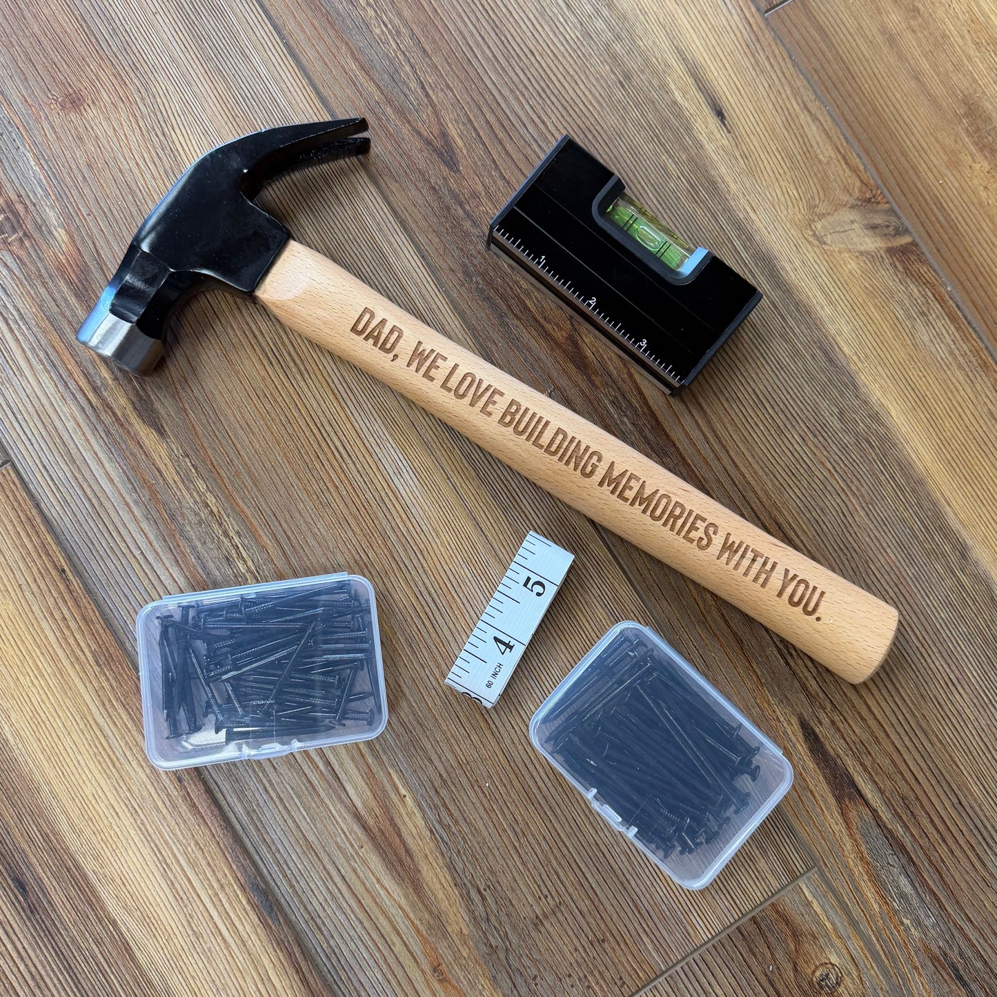 Hammer, level, and containers on a wooden floor