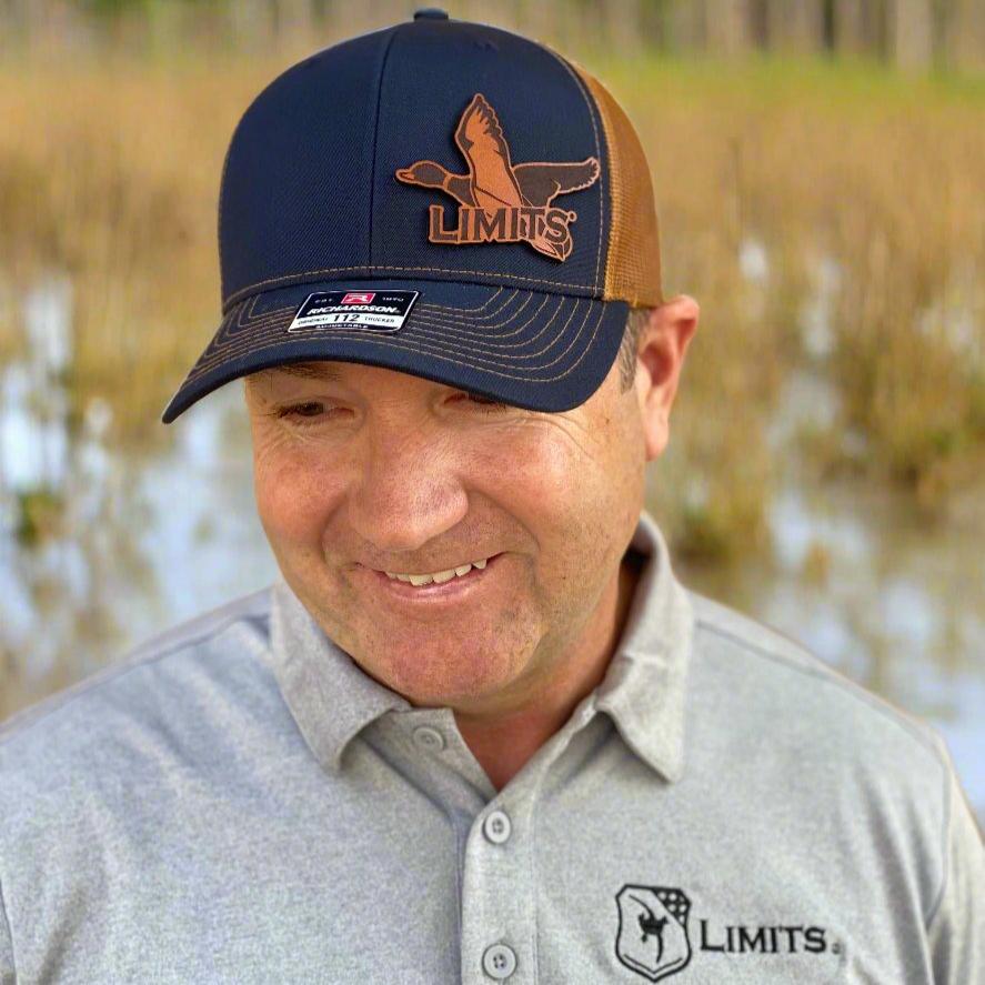 Navy and Caramel Richardson 112 Leather patch hat with the words Limits overlaying on a Mallard Duck image. 