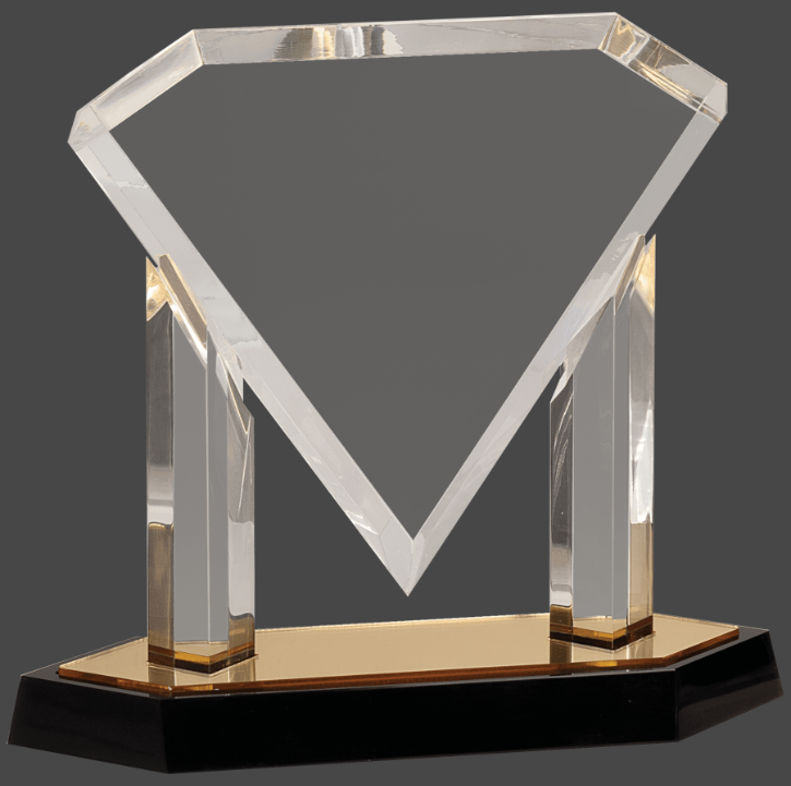 An acrylic award in the shape of a diamond with a reflective surface, featuring a personalized engraving plaque on a mirror base, primarily in gold color.