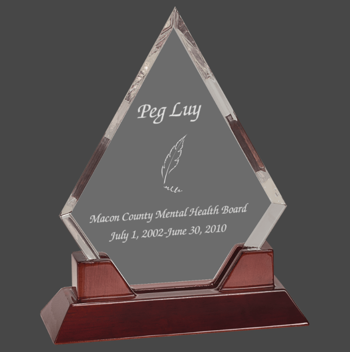 An acrylic award with a personalized engraving plaque on top, mounted on a rosewood piano finish base.
