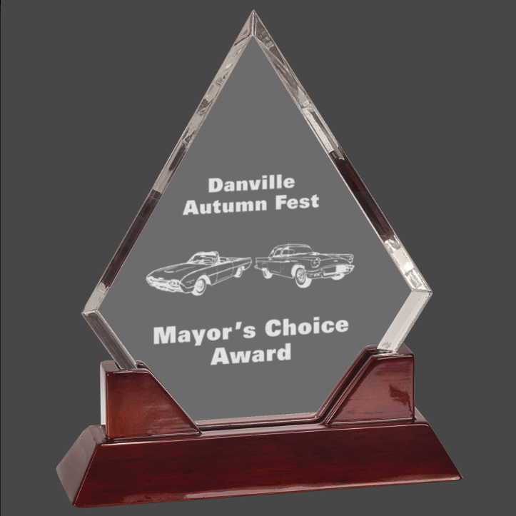 An acrylic award with a personalized engraving plaque on top, mounted on a rosewood piano finish base.