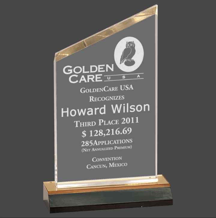 An acrylic clear award , featuring a gold base, and engraved text with a congratulatory message.