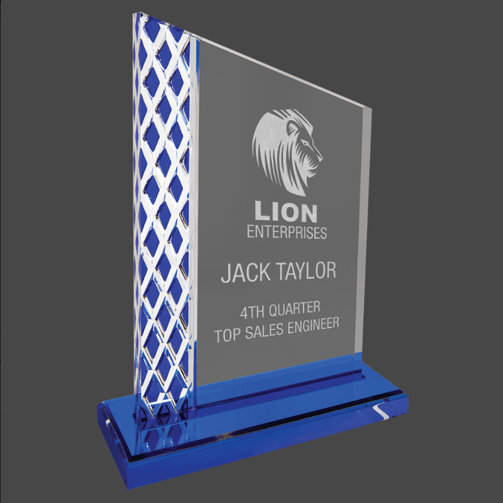 An acrylic award with a blue mirror base, featuring a geometric pattern design on the sides, and a customized engraving plate that reads 'Lion Enterprises' and 'Jack Taylor - 4th Quarter Top Sales Engineer'.