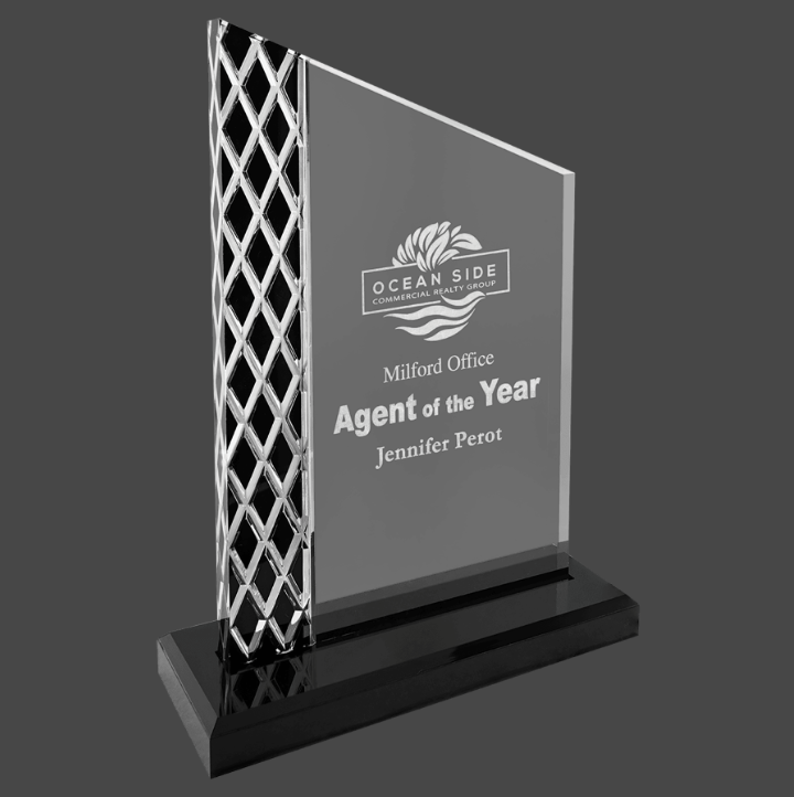 An acrylic award with a black mirror base, featuring a geometric pattern design on the sides, and a customized engraving.