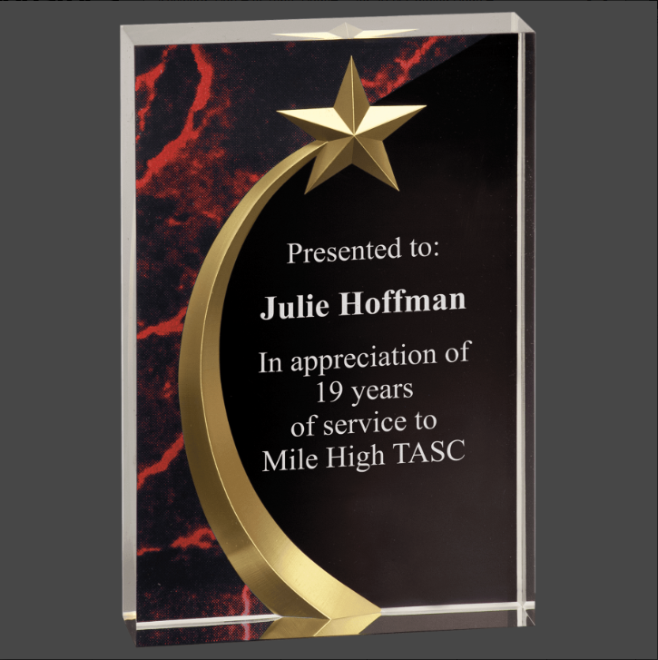 An acrylic award with a shooting star and starburst design, featuring a black textual plaque that reads 'Presented to Julie Hoffman in appreciation of 19 years of service to Mile High TASC'.