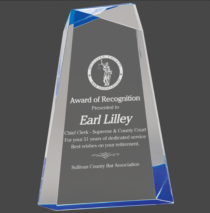 A blue-colored column acrylic award column design and a blue base, featuring engraved text.