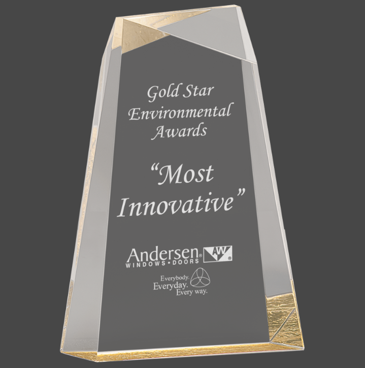 A gold -colored column acrylic award column design and a gold base, featuring engraved text.