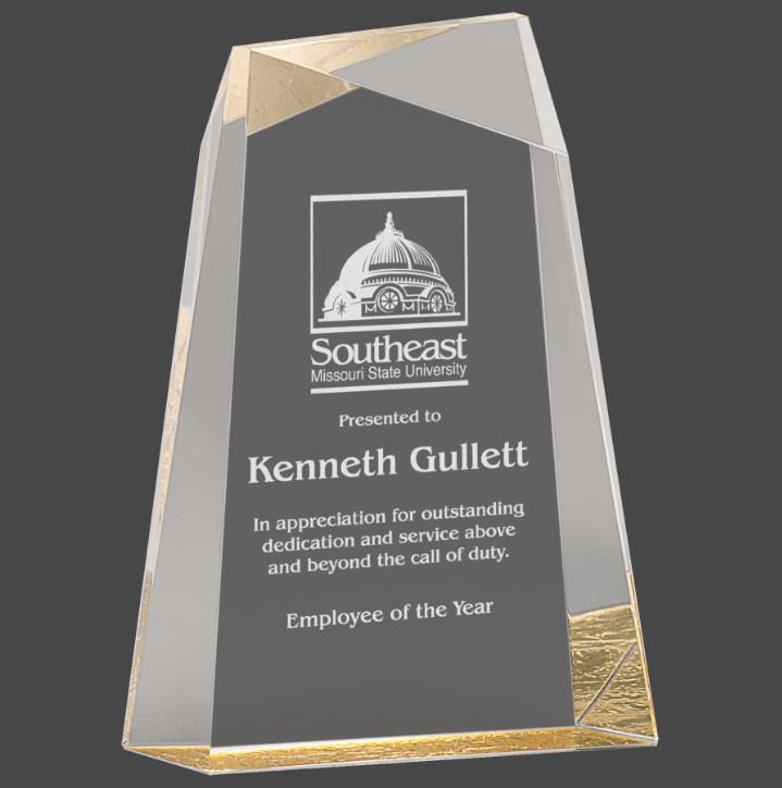 A gold -colored column acrylic award column design and a gold base, featuring engraved text.