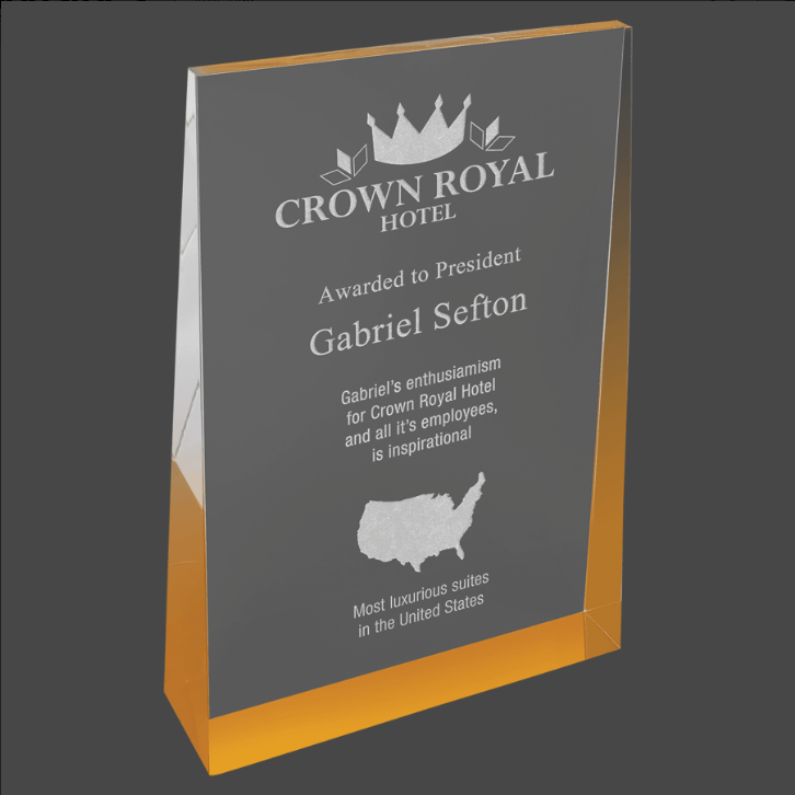 A gold acrylic wedge award with custom laser engraving text and logo.