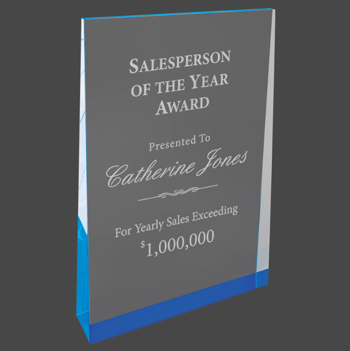 A blue acrylic wedge award with custom laser engraving text and logo.
