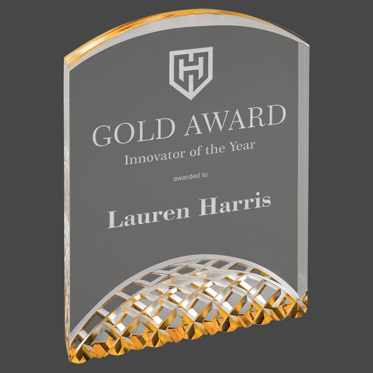 An engraved acrylic award with a gold, silver, and black geometric pattern on the border, featuring a personalized inscription.