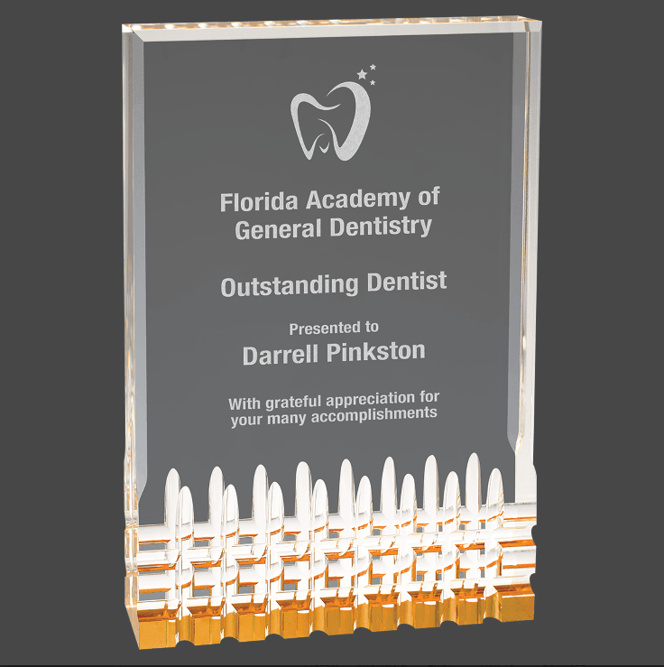 A gold mirage acrylic award with custom laser engraving, featuring text and a logo.